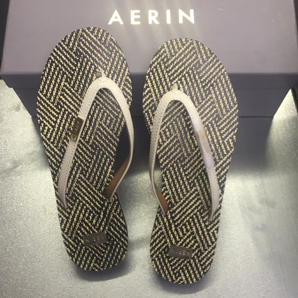 Aerin New Patent flip flop with gold details.